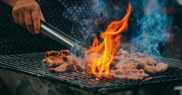 Barbecue - Close-Up Photo of Man Cooking Meat