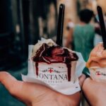 Food Tours - Crop anonymous couple with delicious ice cream in hands during walk in narrow street in historic city centre