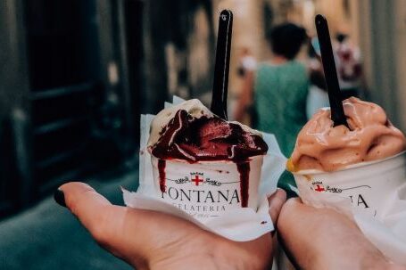Food Tours - Crop anonymous couple with delicious ice cream in hands during walk in narrow street in historic city centre