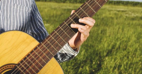 Country Music - Person Playing Guitar in Grass Field