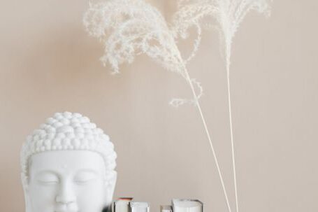 Historic Home - Vase with dried herbs arranged with Buddha bust and books