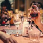 Wine Tasting - People Drinking Liquor and Talking on Dining Table Close-up Photo