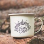 Camping - White Happy Camper-printed Cup on Brown Wooden Log